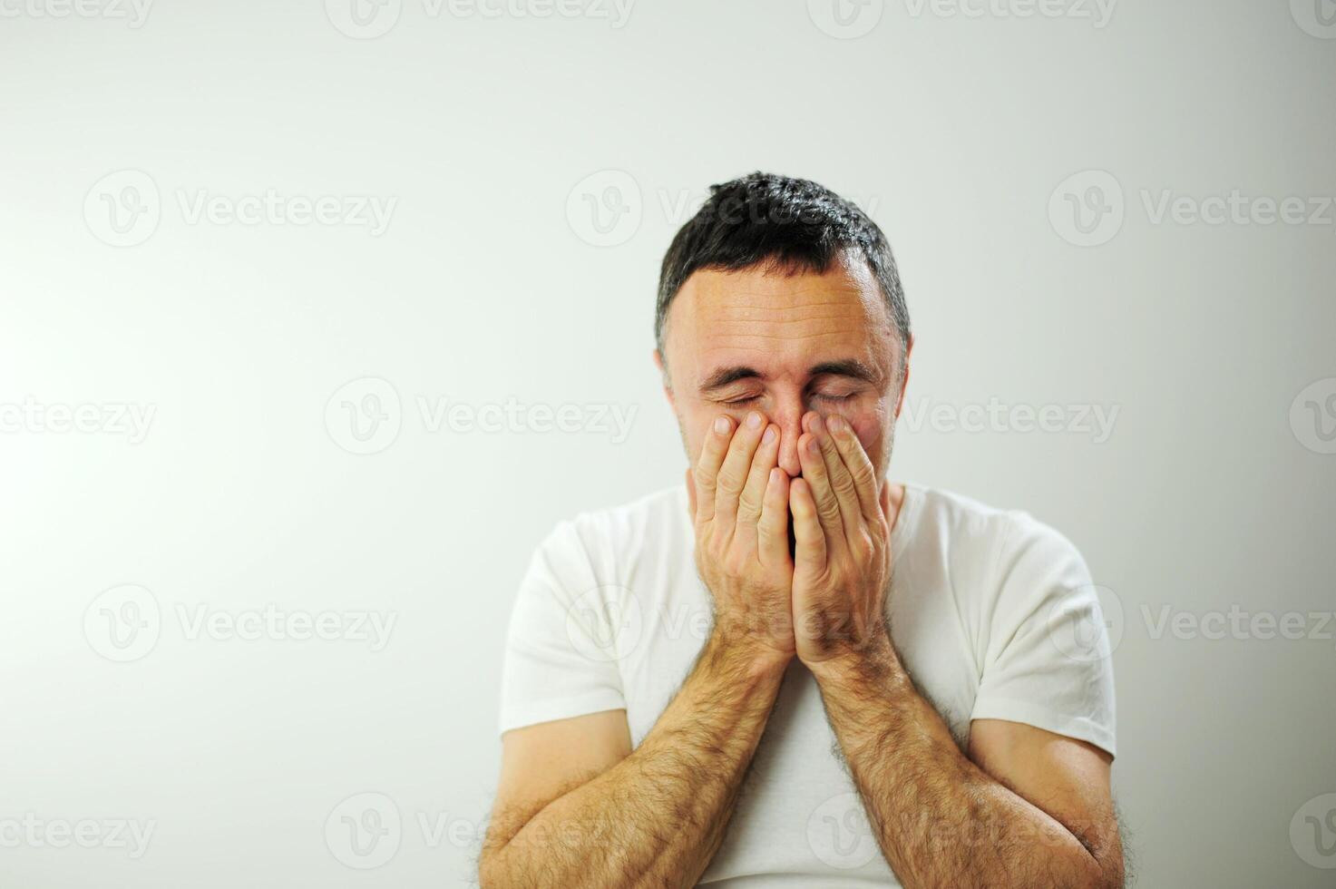 Adult man upset he put his hands on his face Prayer experience crying negative emotions suffering loneliness Studio on white background Close-up space for text Waiting for the end of the war photo