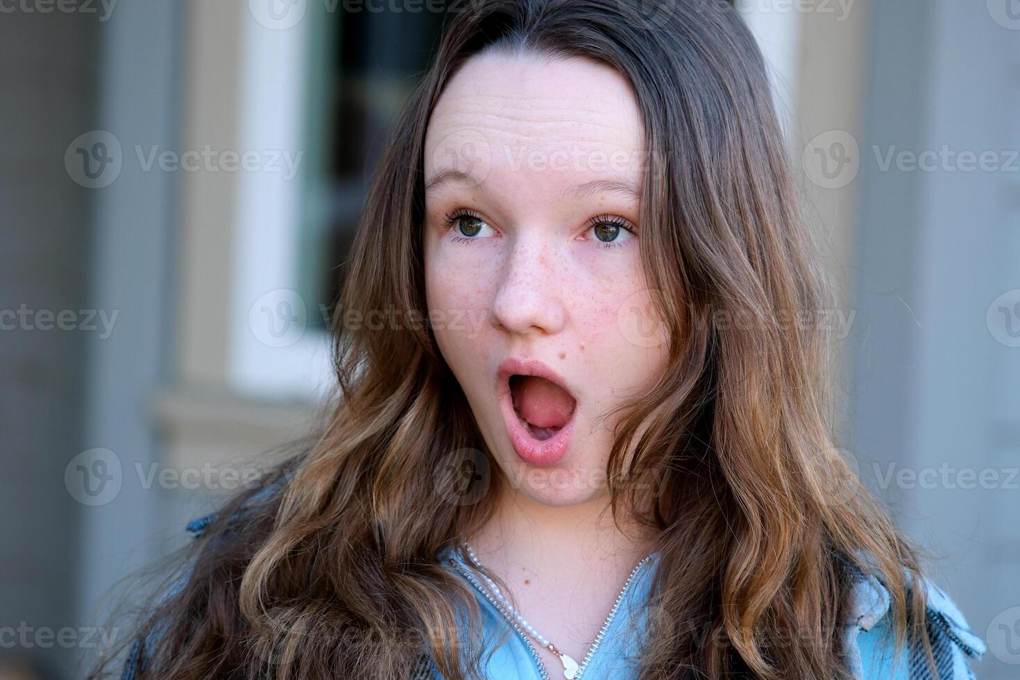 Beautiful european cute teen girl get surprised when look at copy space. Surprised happy beautiful woman looking copy space in exciting. use for your product, advertising. photo