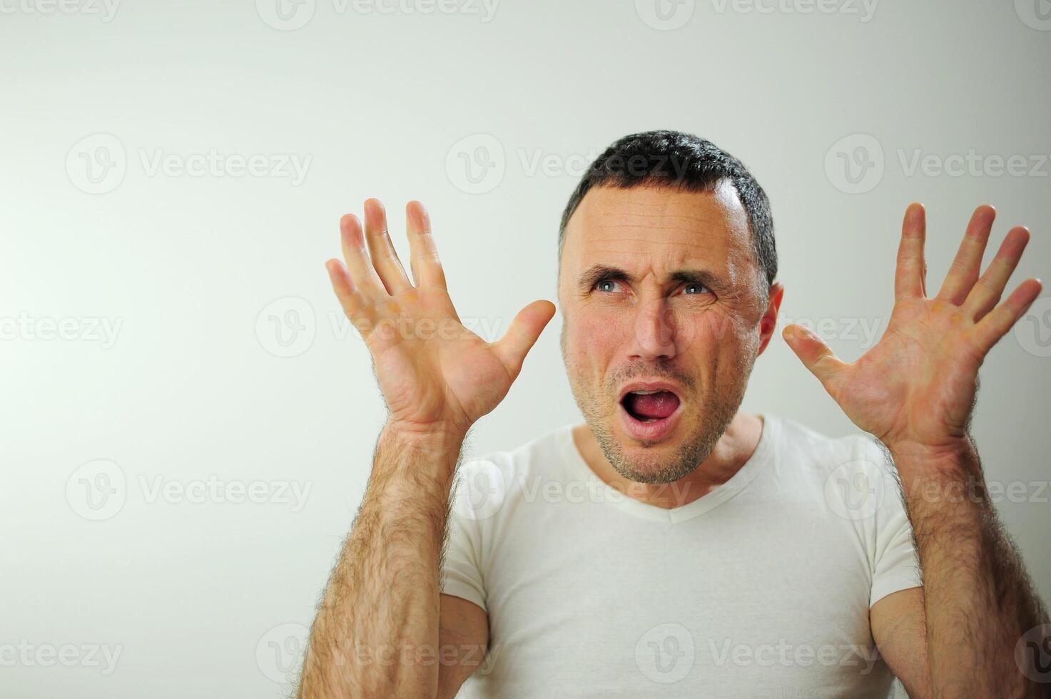 Appalled man emotional guy feeling sinking heart shortness of breath about emotional stress sensations isolated on grey white studio background, frightened person, horror, panic attack concept photo
