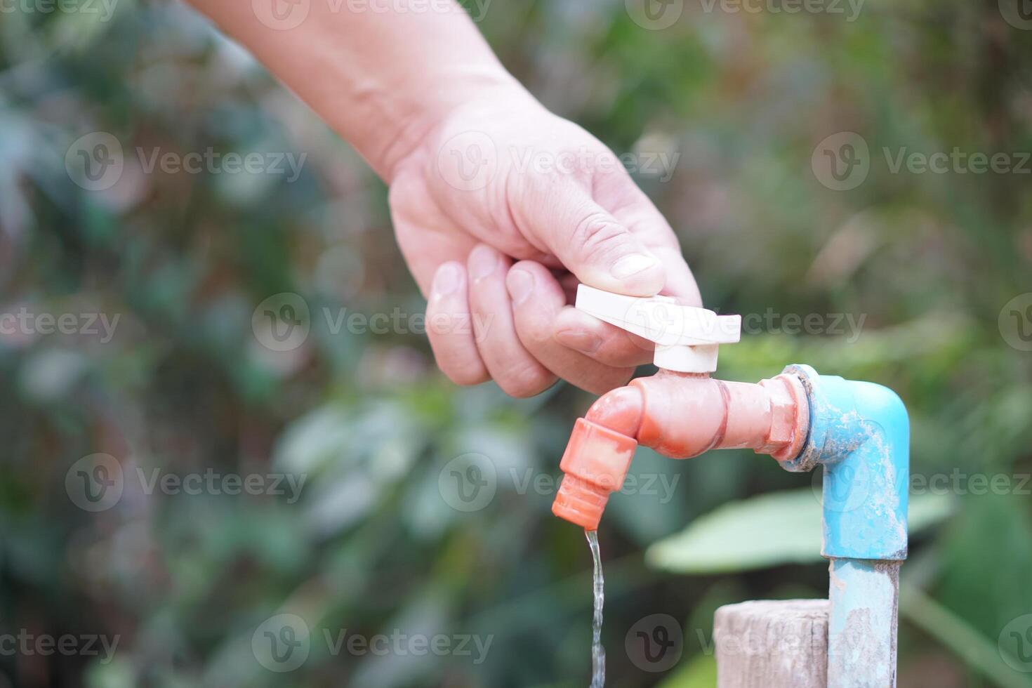 Close up hand is turning off faucet. Concept, Save water for environment. Turn off tap or faucet before leaving. Don't waste water by let it dripping or leaking. photo