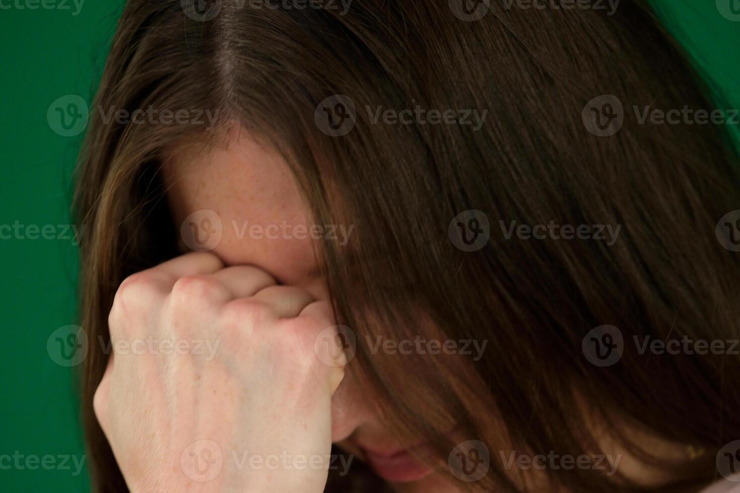 closeup portrait of a scared woman crying with bruises and wounds marks on her face after case of gender violence in a young couple photo