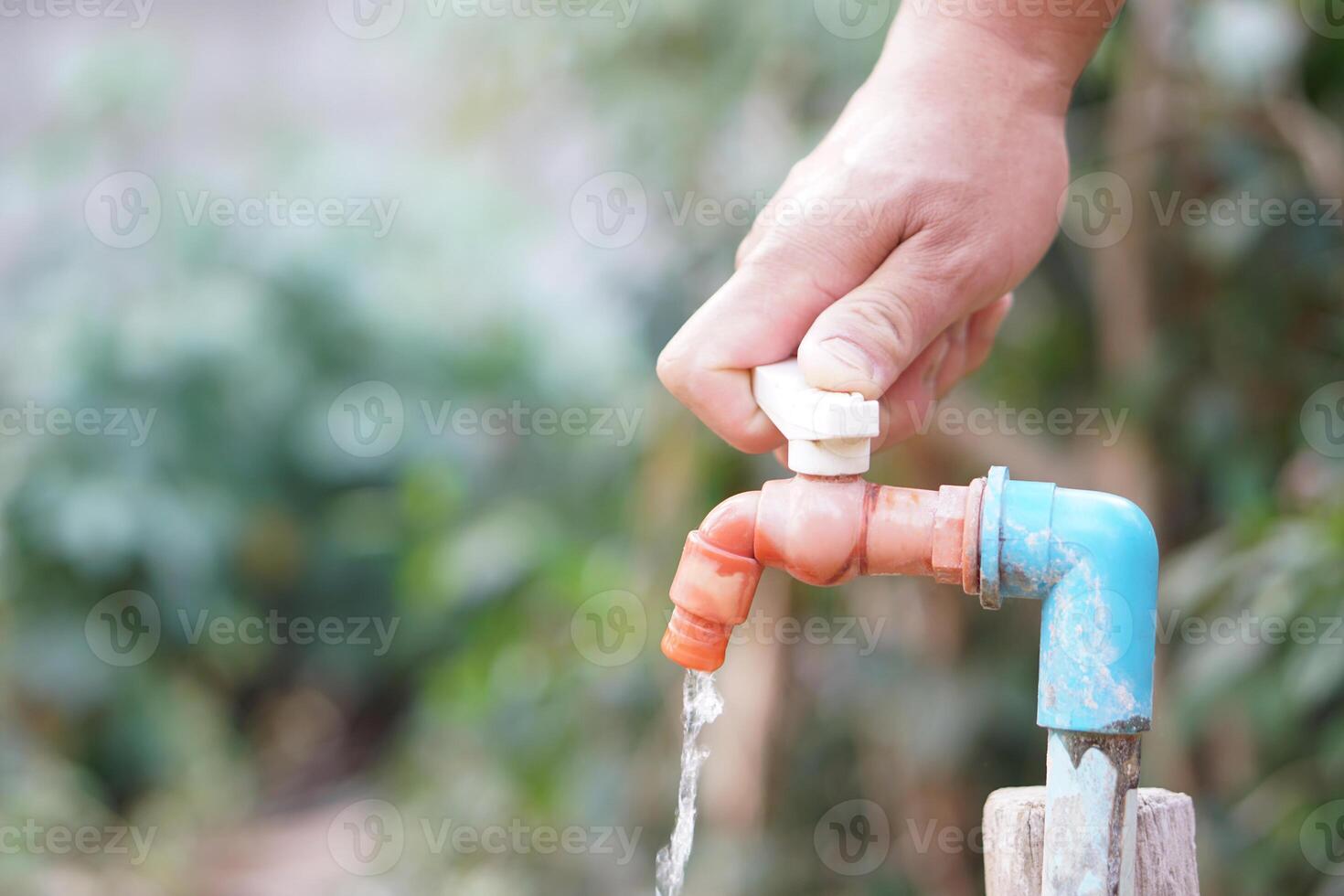 Close up hand is turning off faucet. Concept, Save water for environment. Turn off tap or faucet before leaving. Don't waste water by let it dripping or leaking. photo