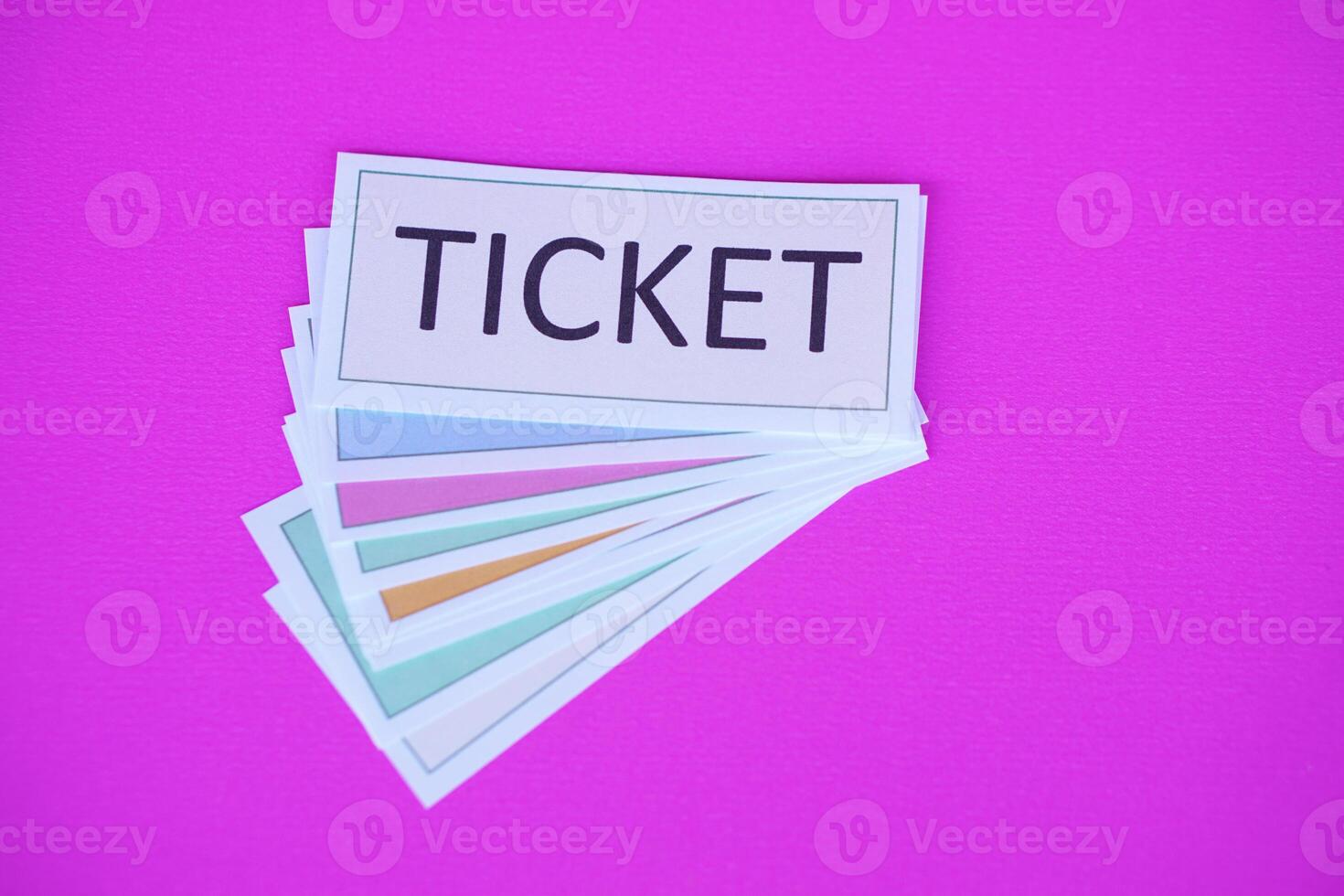 Pile of overlapped ticket paper cards on pink background. Concept, tickets for passing or enter to join activity or public vehicles. Tickets for playing games. Teaching aids. photo