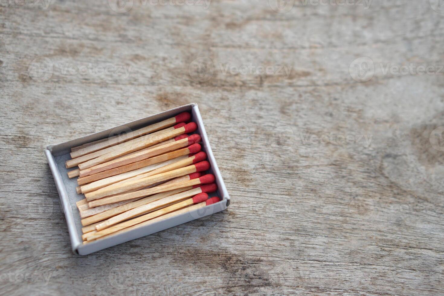 Box of matches wooden sticks with red sulfur. Concept, tool or equipment used for igniting fire made from small wooden sticks. with flammable substance on one end. photo