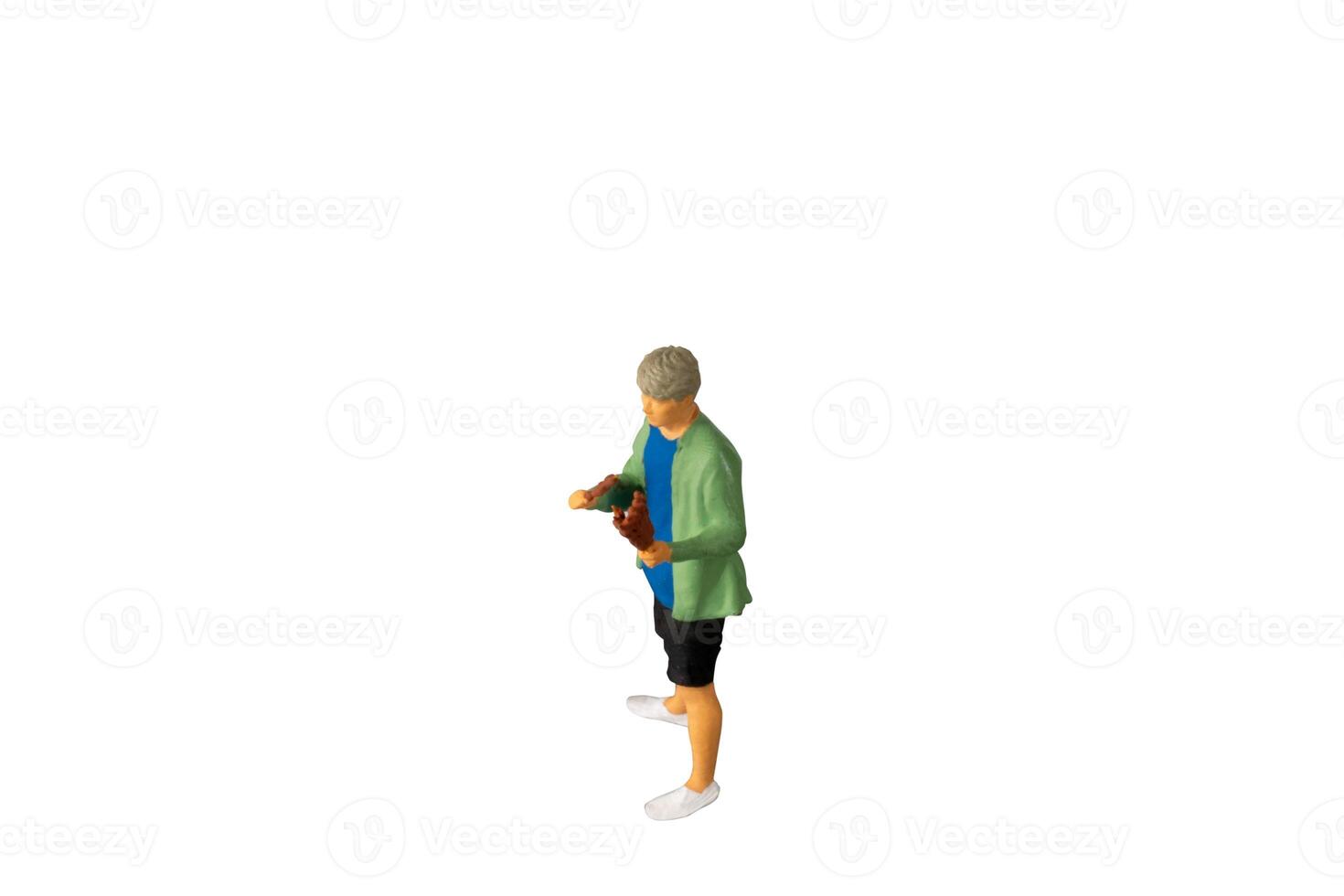 Miniature people , A young man with a BBQ Isolated on white background with clipping path photo