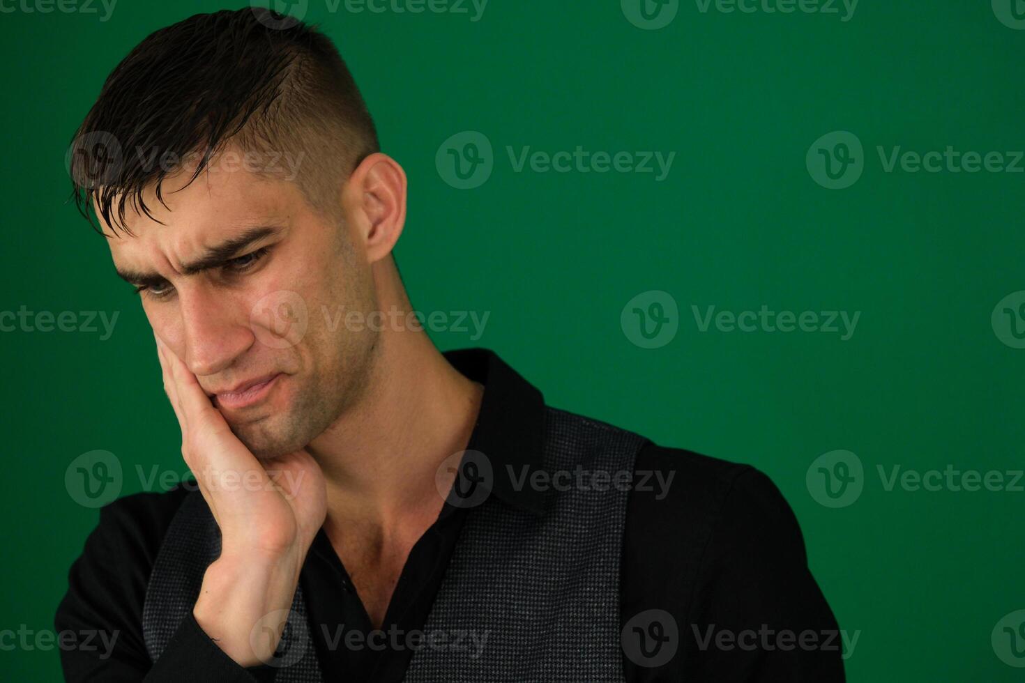 Men Toothache emotions of a handsome man guy on a green background chromakey close-up dark hair young man photo
