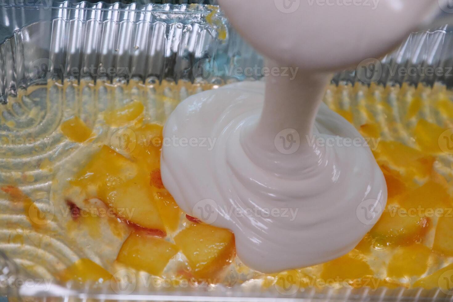 pour several layers of fruit jelly into a plastic container peaches blueberries curd dessert using gelatin for healthy joints in home cooking food photo