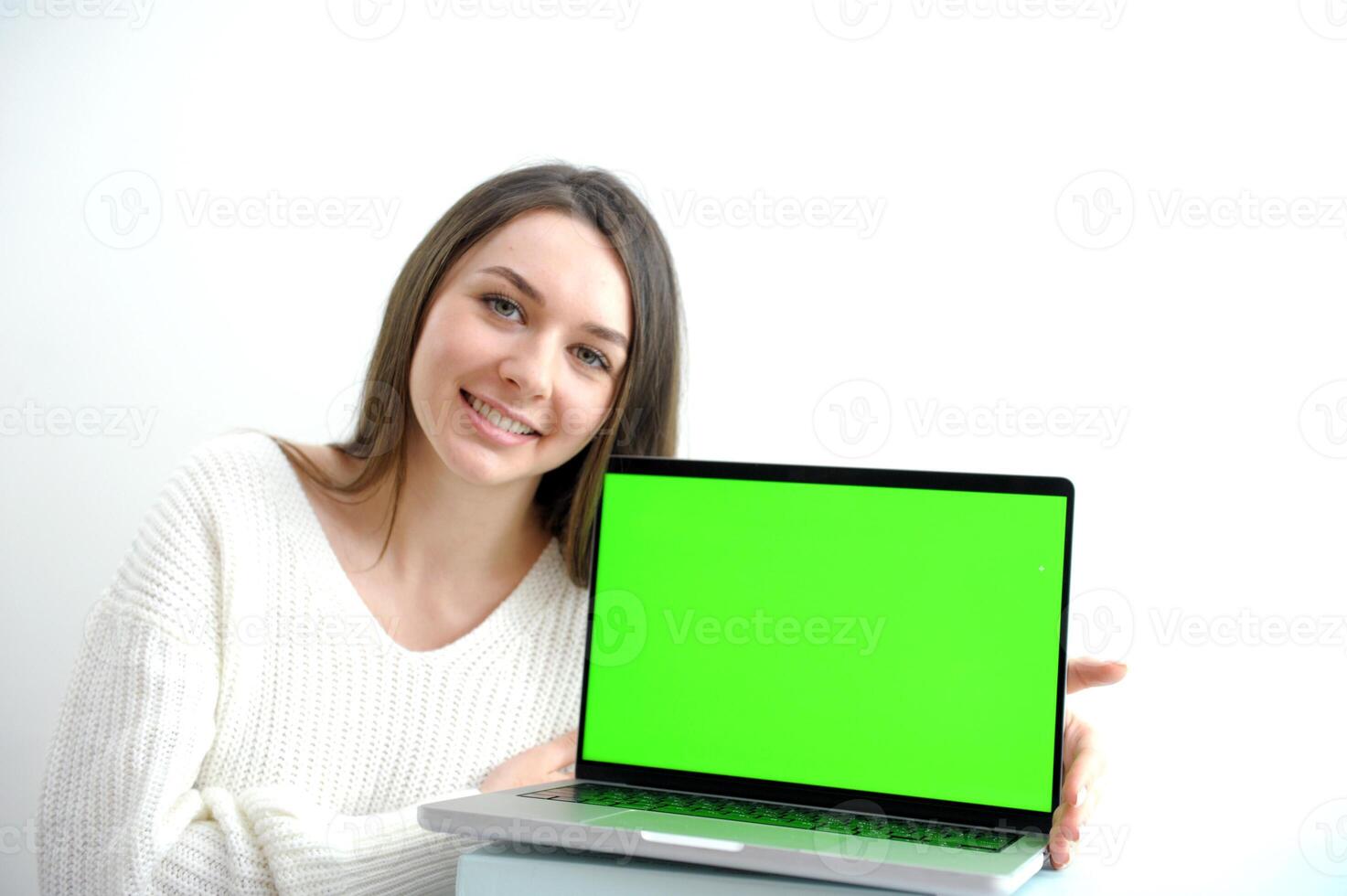 Woman freelancer is working on a new project on computer. White Display. photo