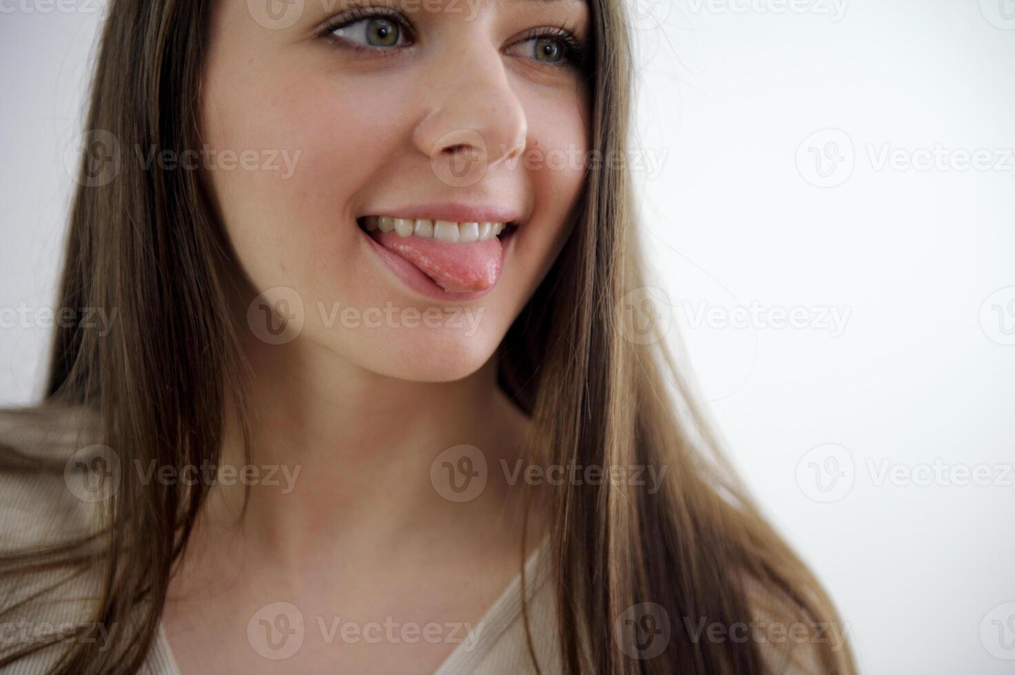 Slow motion close up portrait of an adult woman,smiling presenting with her optimistic,carefree ,vibrant attitude and sparkling white teeth.Concept of happy mood,oral hygiene,dental care. photo