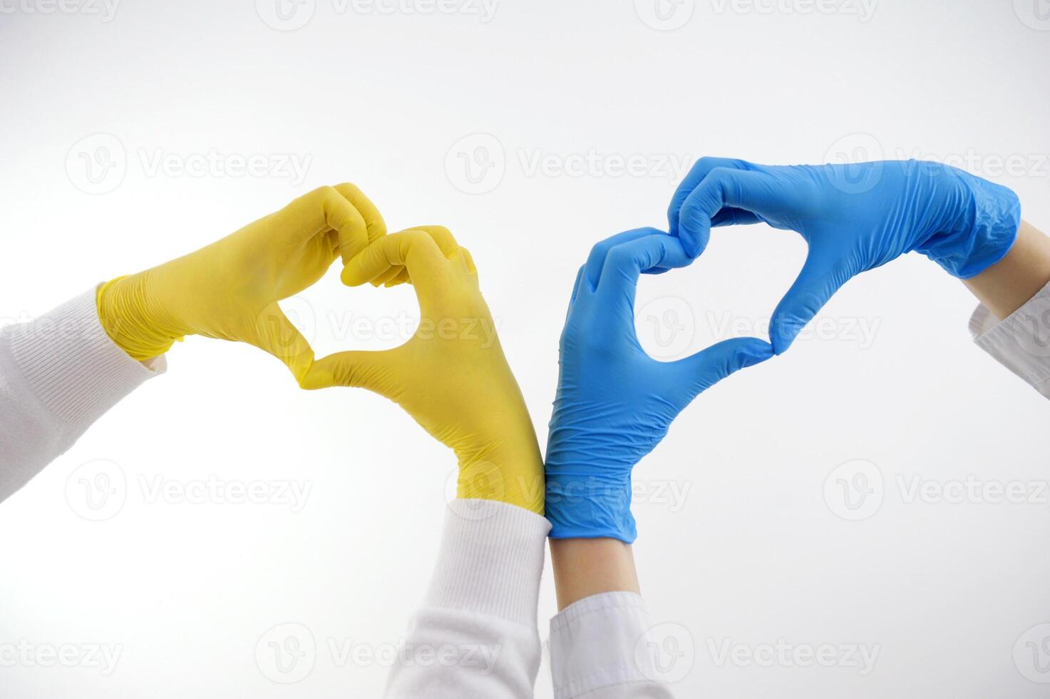 Hands forming a heart in colors of national flag of Ukraine. Isolated on white background with clipping path. peace love friendship no war help medical care doctors make heart with hands on photo