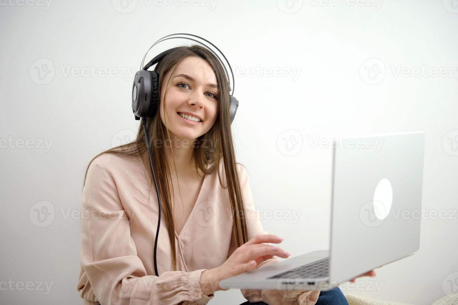 Engaged in distant training. Active young woman remote worker take part in virtual meeting using home computer. Female student participate in conference wearing headset. photo