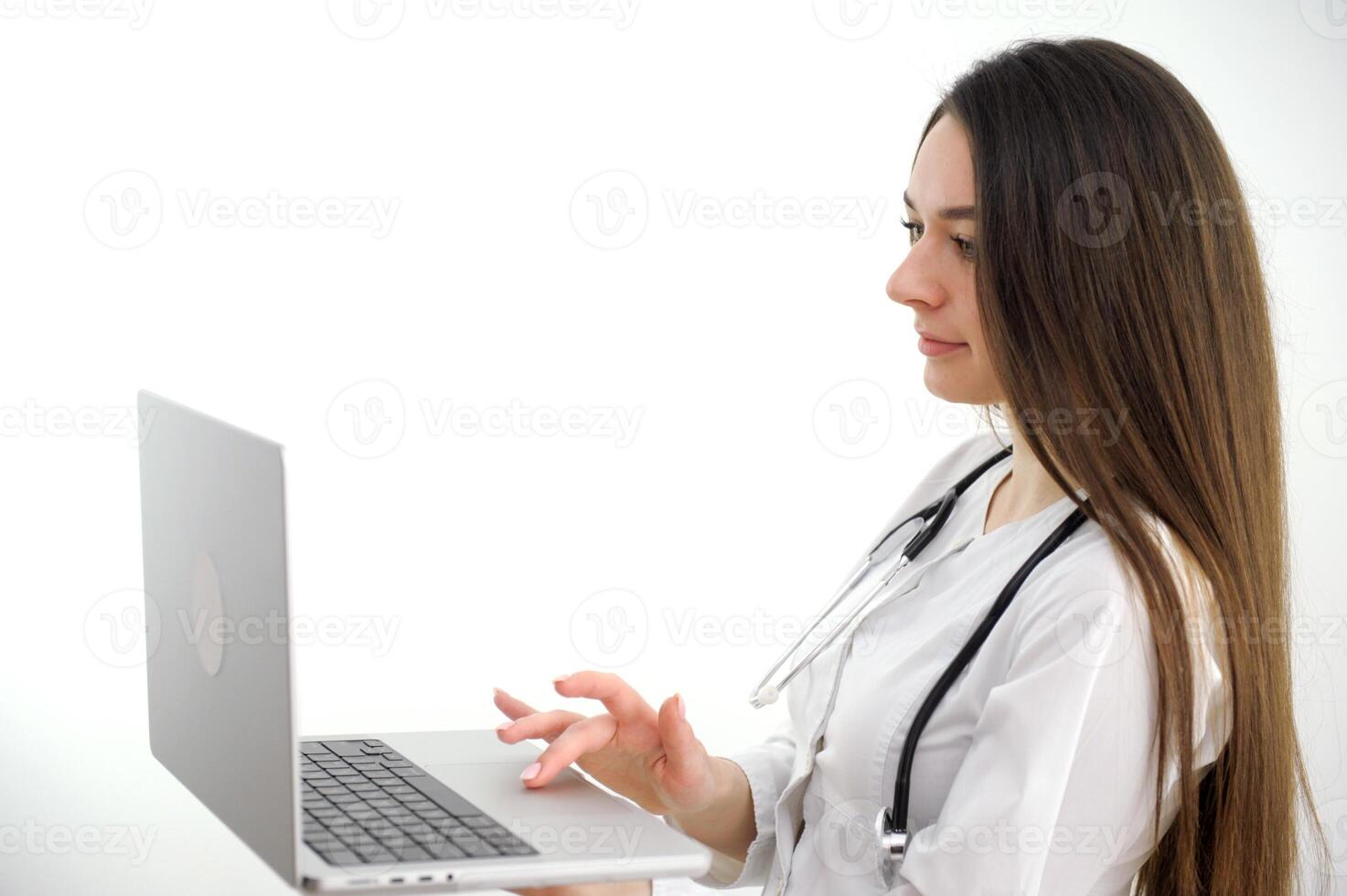 Girl doctor young light background studio day beautiful one positive tablet looking smiling concept of remote customer care online patients. photo