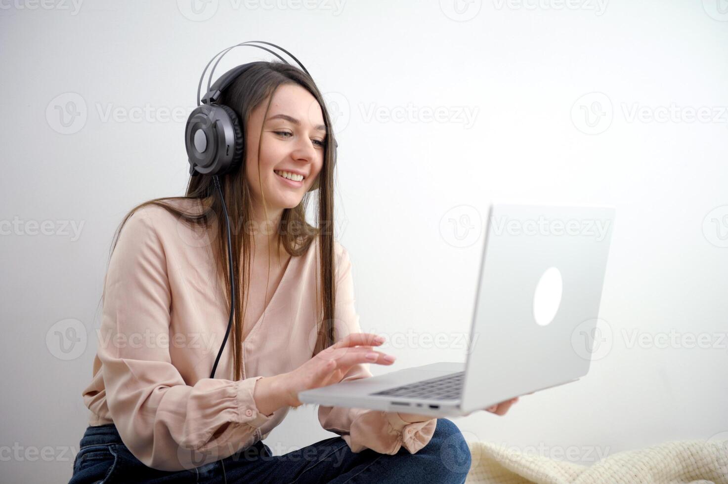 Business woman wearing white headphones doing call at work photo