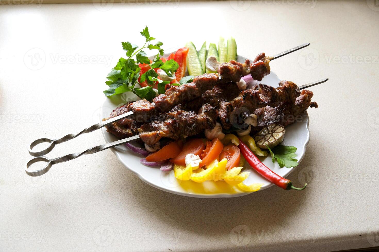 Shish kebab with mushrooms, cherry tomato and sweet pepper, Grilled meat skewers. Top view, copyspace. most important meat dish of Turkish cuisine kebabs is a rich product that is cooked on embers photo