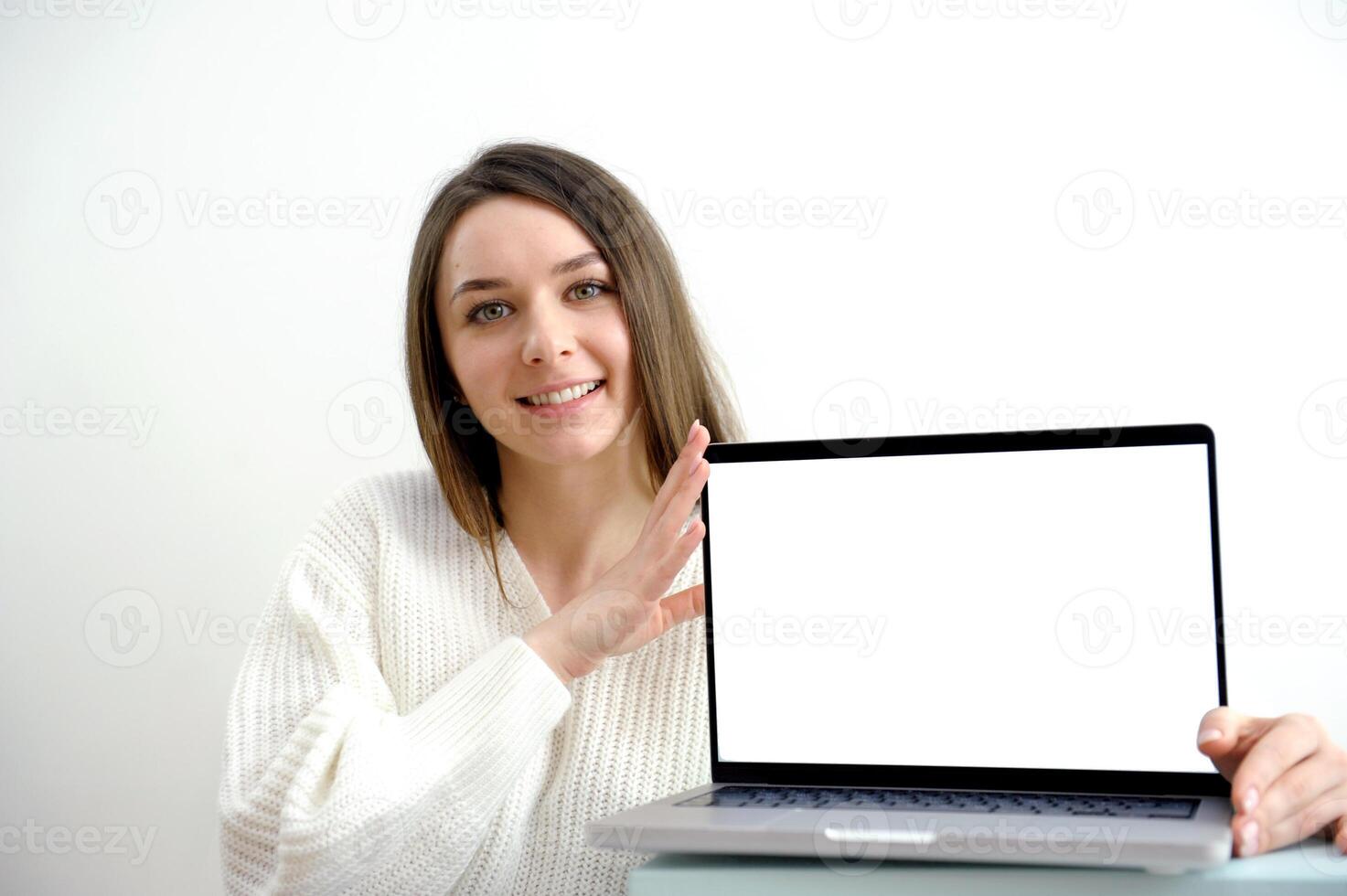 Woman freelancer is working on a new project on computer. White Display. photo