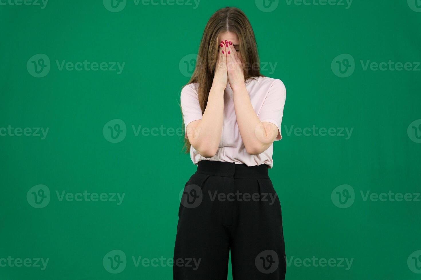 Young redhead woman with apron with tired and sick expression over green background photo