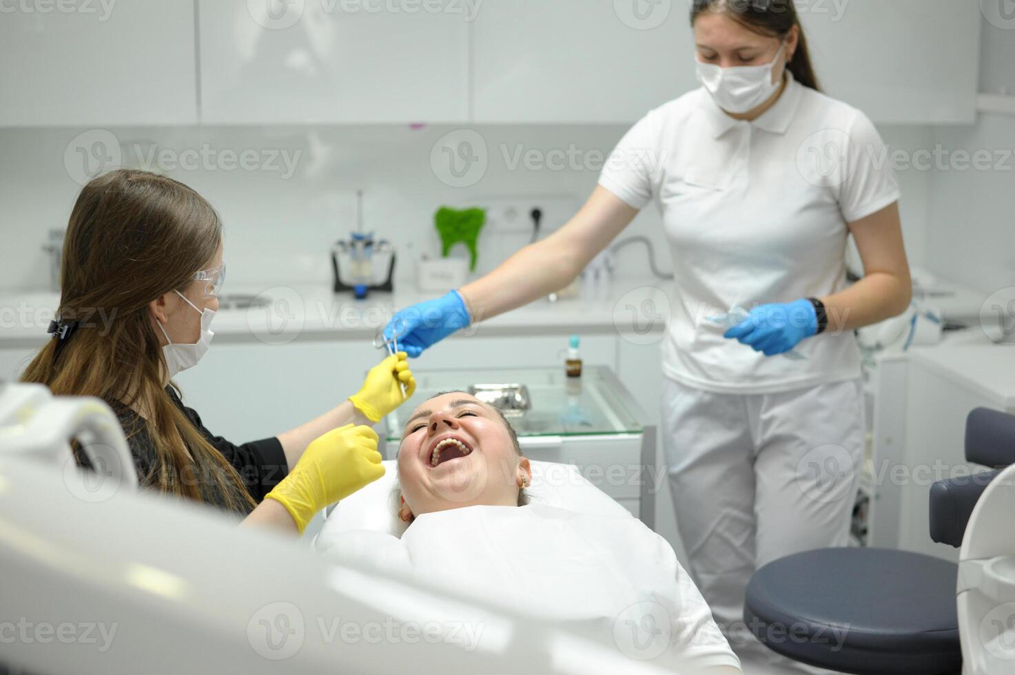 Doctor woman dentist treats the patient's teeth, proper dental care. Dental care and hygiene concept. Selective focus. photo
