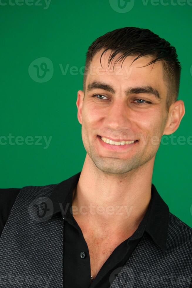 handsome man black jacket fashion hairstyle close-up attractive look model emotions of a handsome man guy on a green background chromakey close-up dark hair young man photo