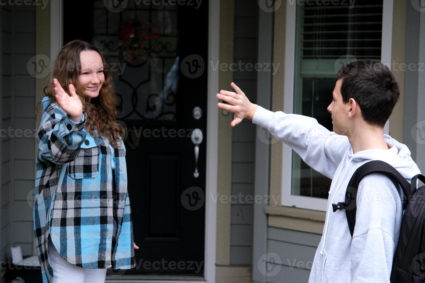 young couple, man and woman in Amsterdam, Netherlands, standing in front of entrance door, holding each others hands photo