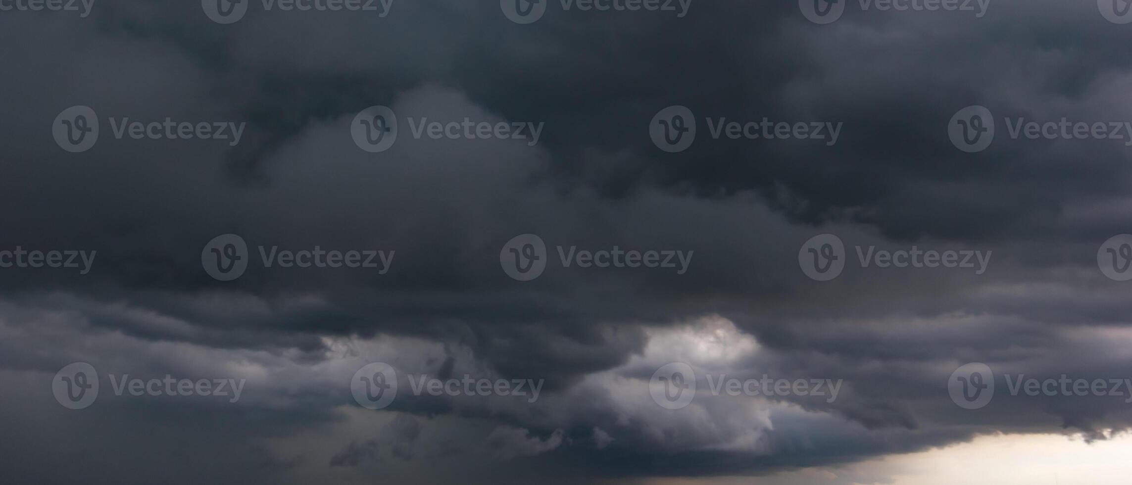 Bad or night weather sky and environment.The dark sky with heavy clouds converging and a hurricane storm before the rain. carbon dioxide emissions, greenhouse effect, global warming, climate change photo