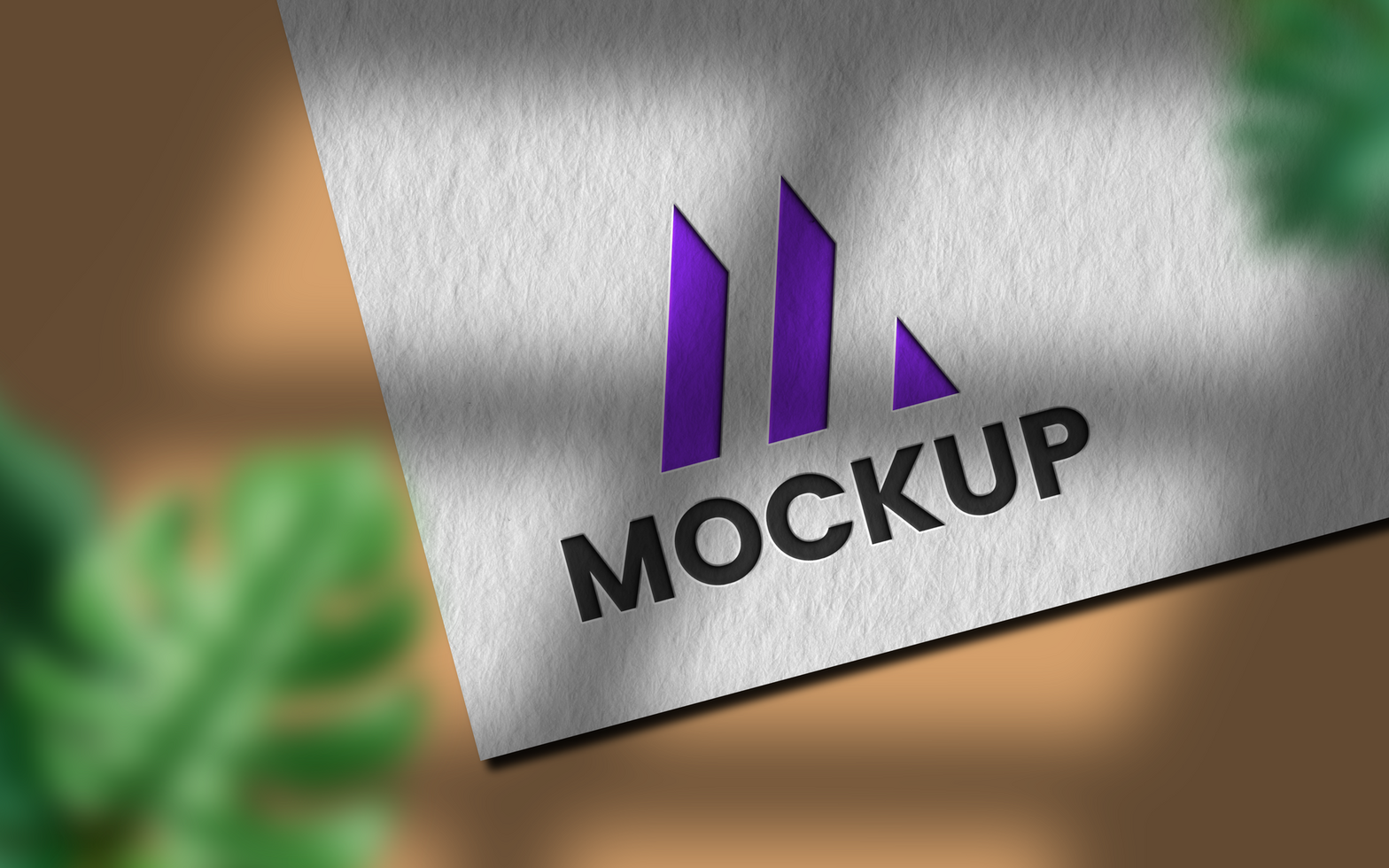 debossed logo mockup on paper with leaves psd