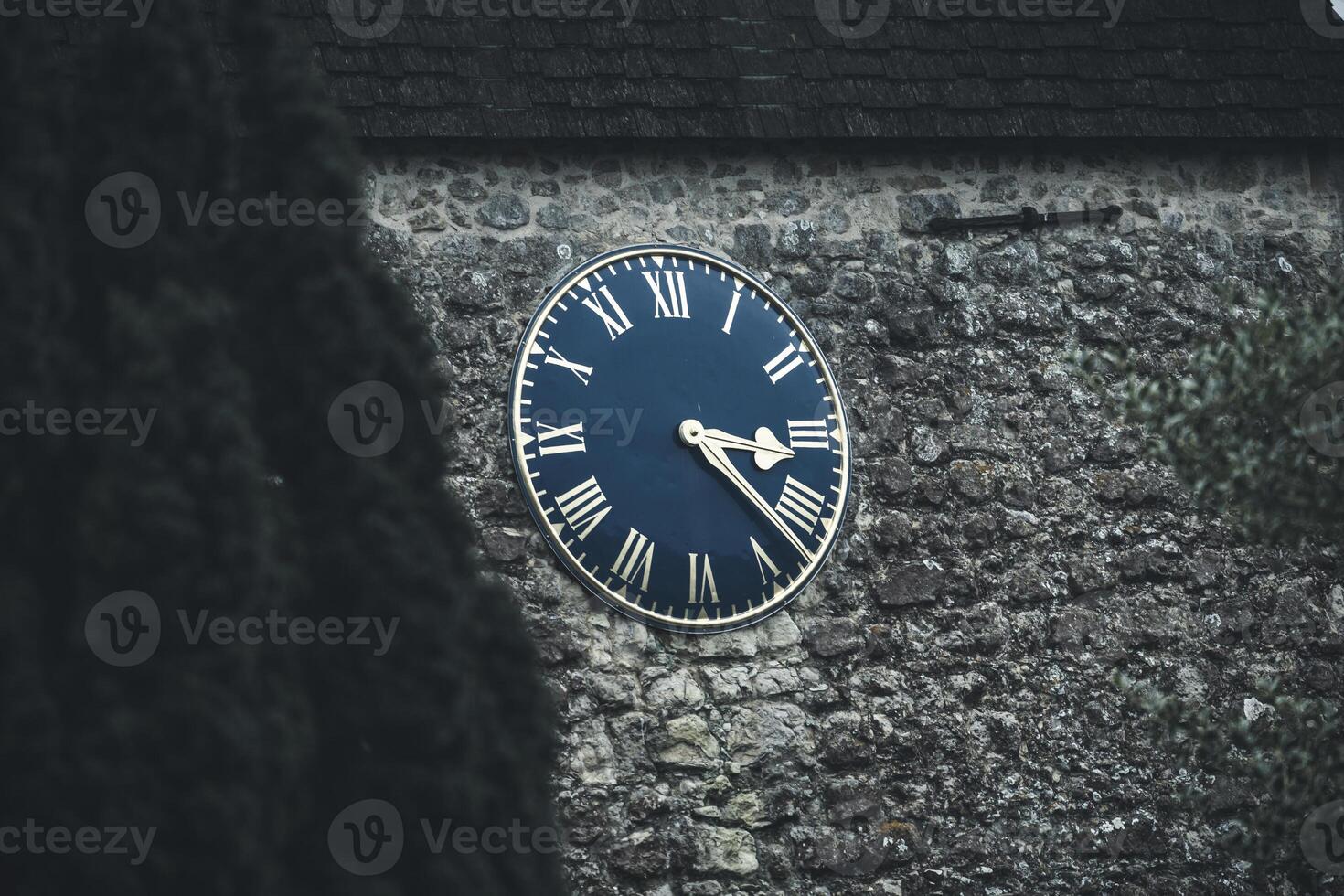 Timeless Elegance Close-Up of an Old English Clock Tower with Roman Numerals photo