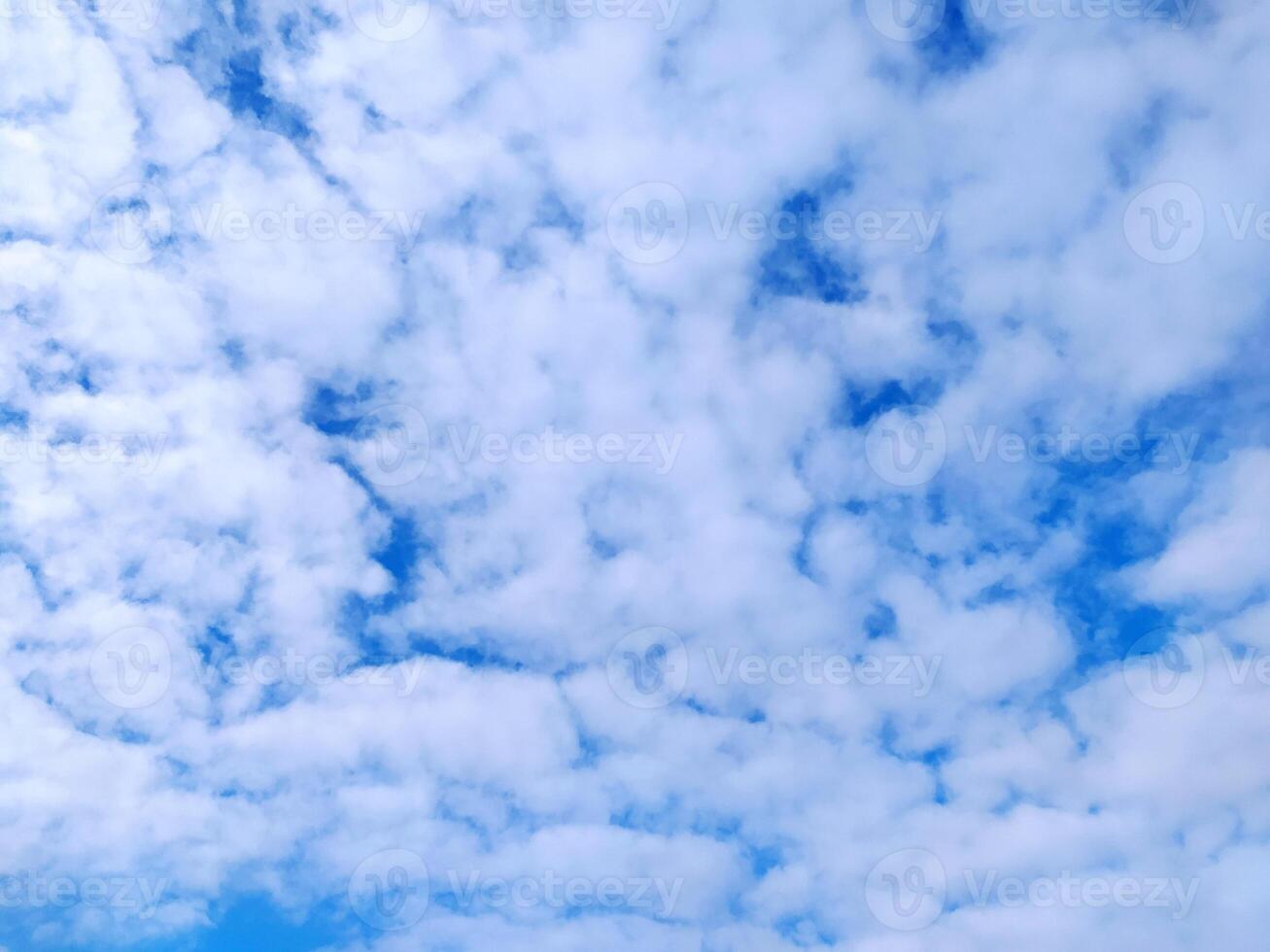 Clear blue sky texture and white fluffy cloud nature background. The sun shines bright in the daytime in summer photo