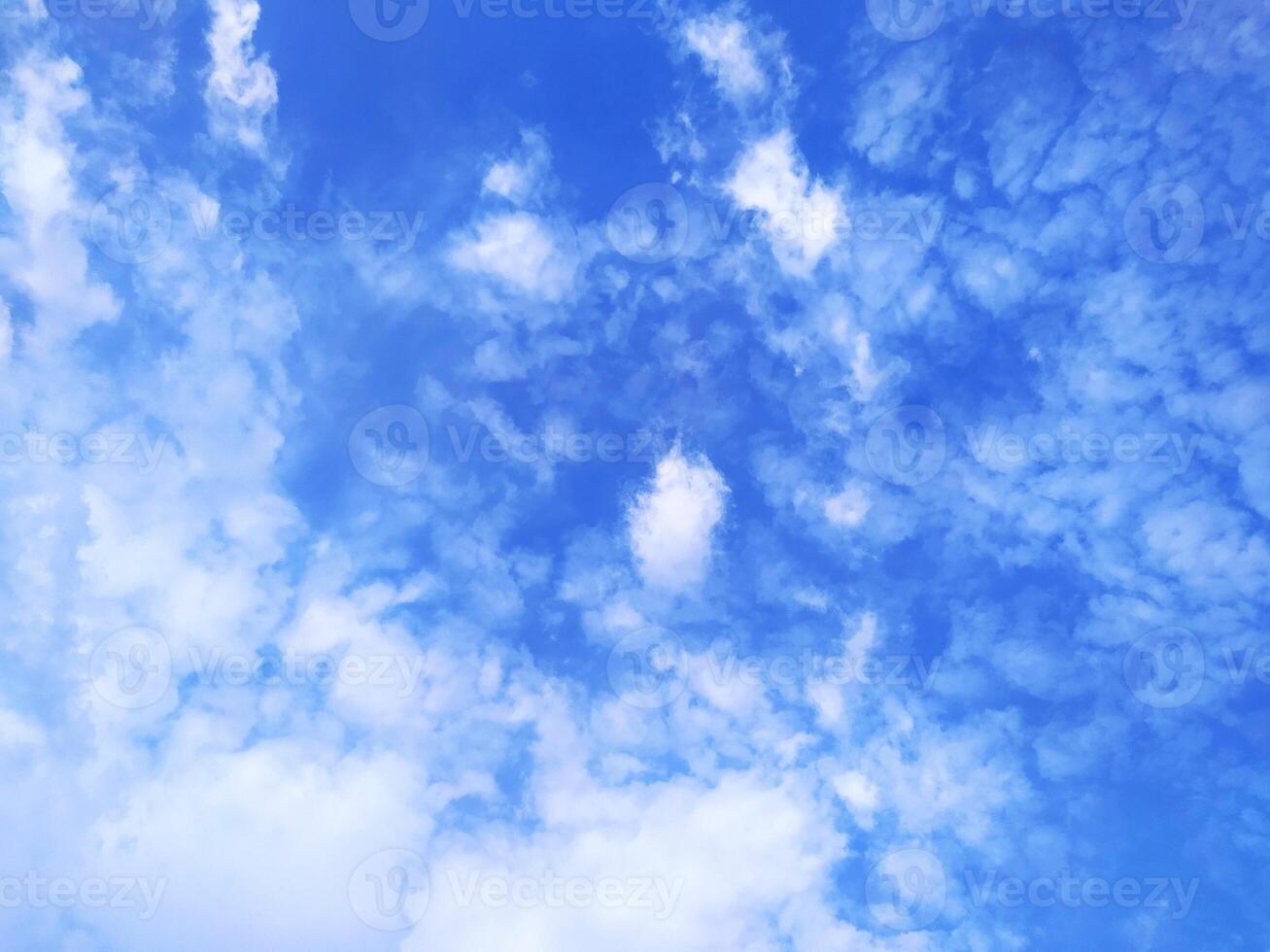 Clear blue sky texture and white fluffy cloud nature background. The sun shines bright in the daytime in summer photo