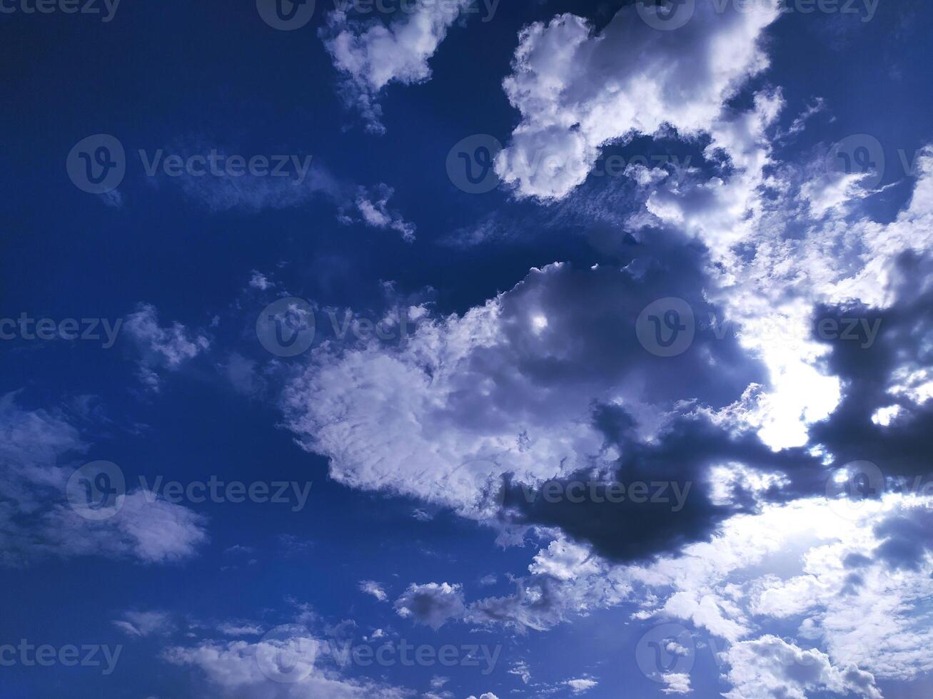 Clear blue sky texture and white fluffy cloud nature background. The sun shines bright in the daytime in summer photo