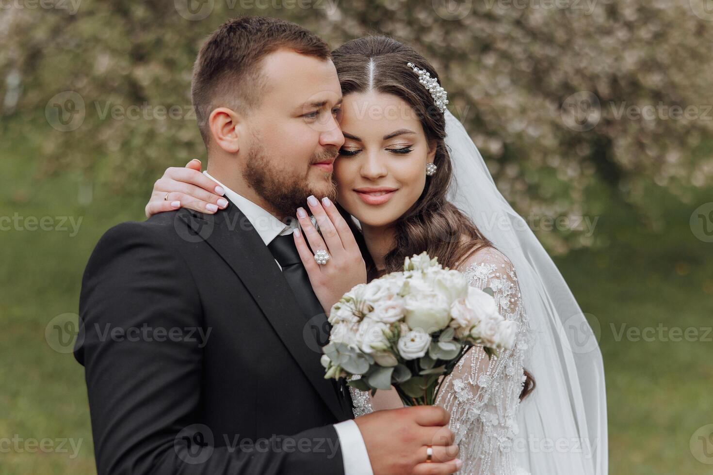 A bride and groom are hugging each other photo