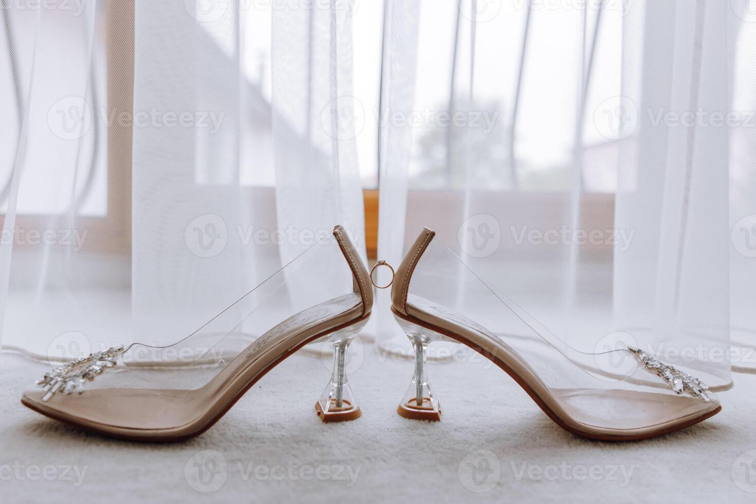 Two pairs of high heels with clear soles and a diamond-studded strap photo
