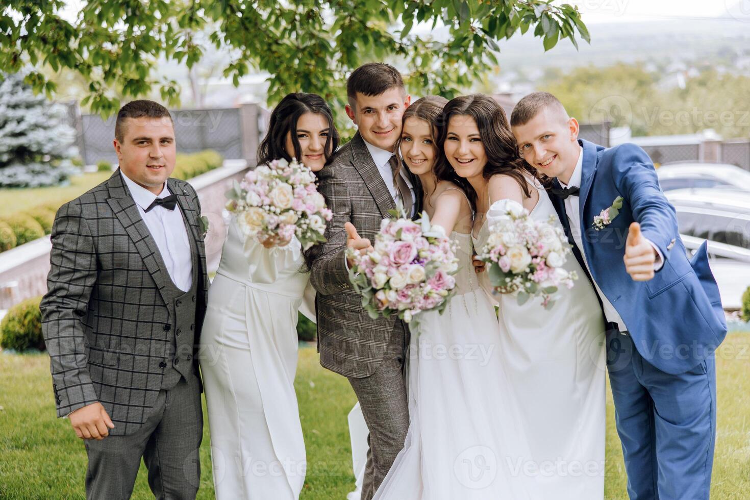 A group of people posing for a picture, including a bride and groom photo