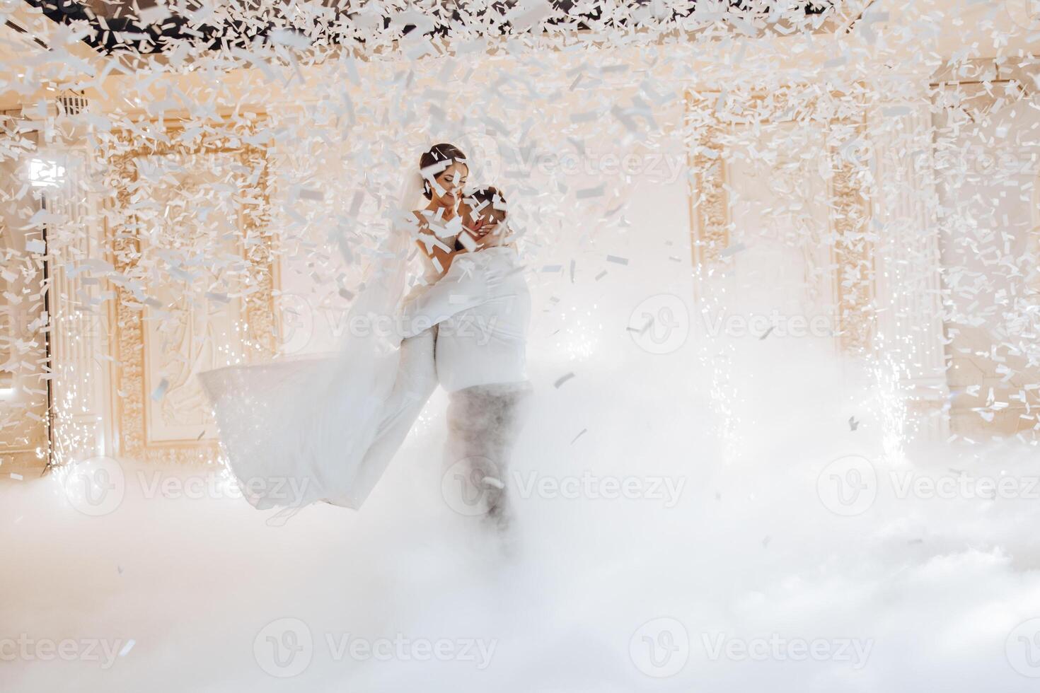 A bride and groom are dancing in the air in a snowstorm photo