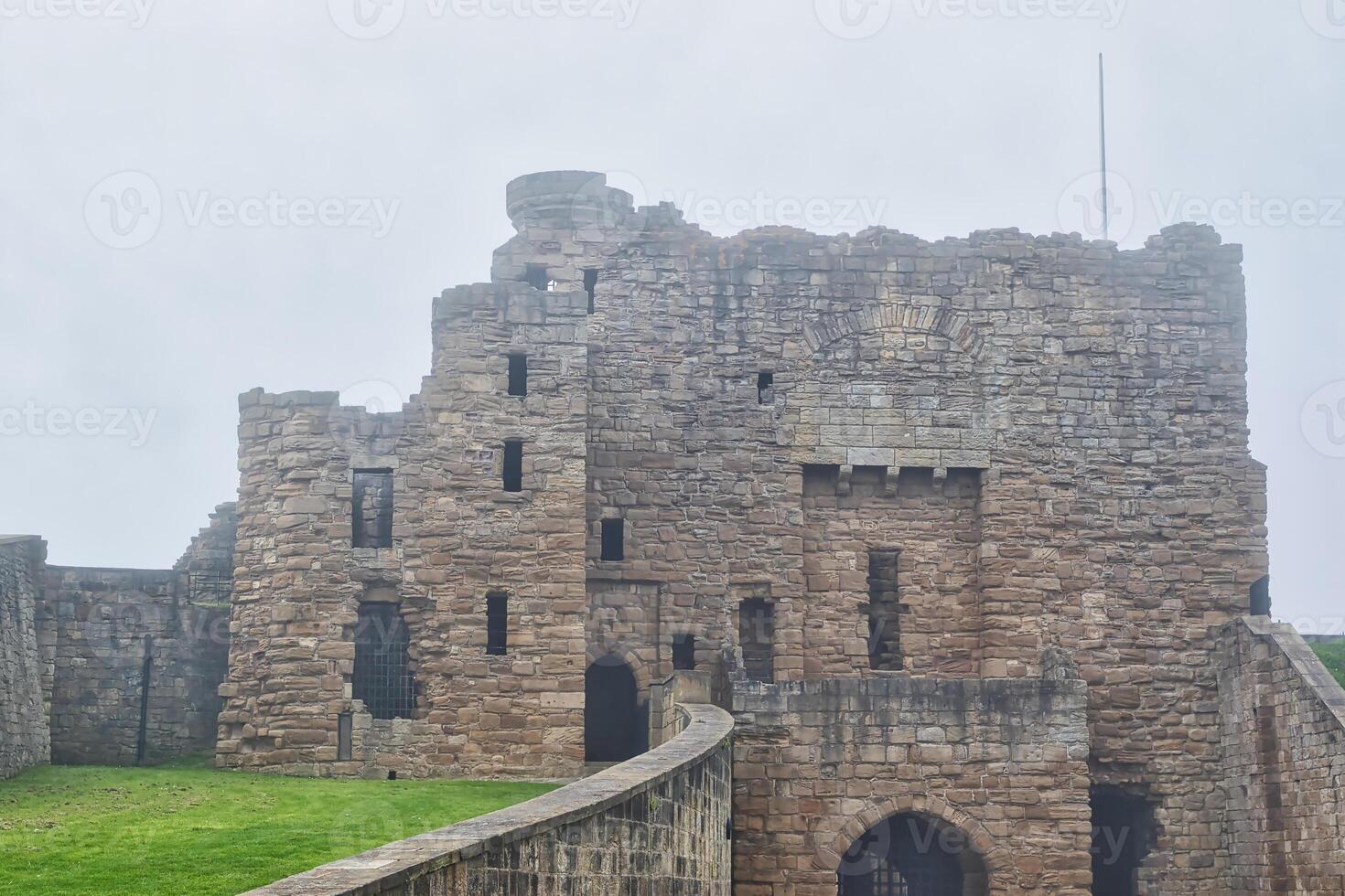 Historic stone castle with tower on an overcast day in Tynemouth Priory and Castle photo