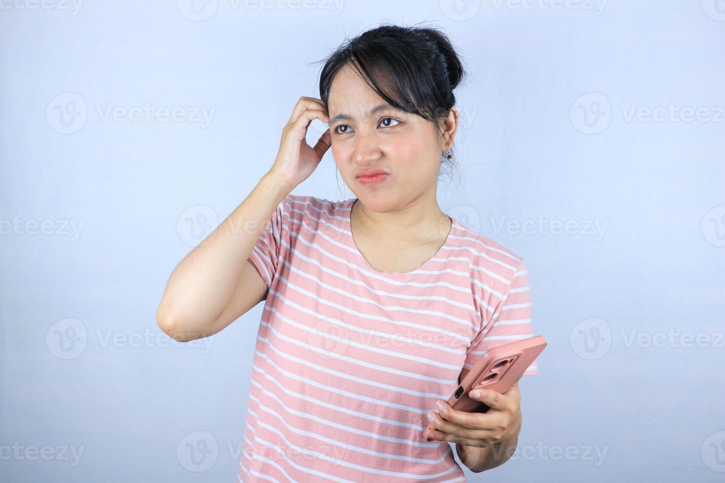 confuse expression of Asian woman holding smart phone on white background photo