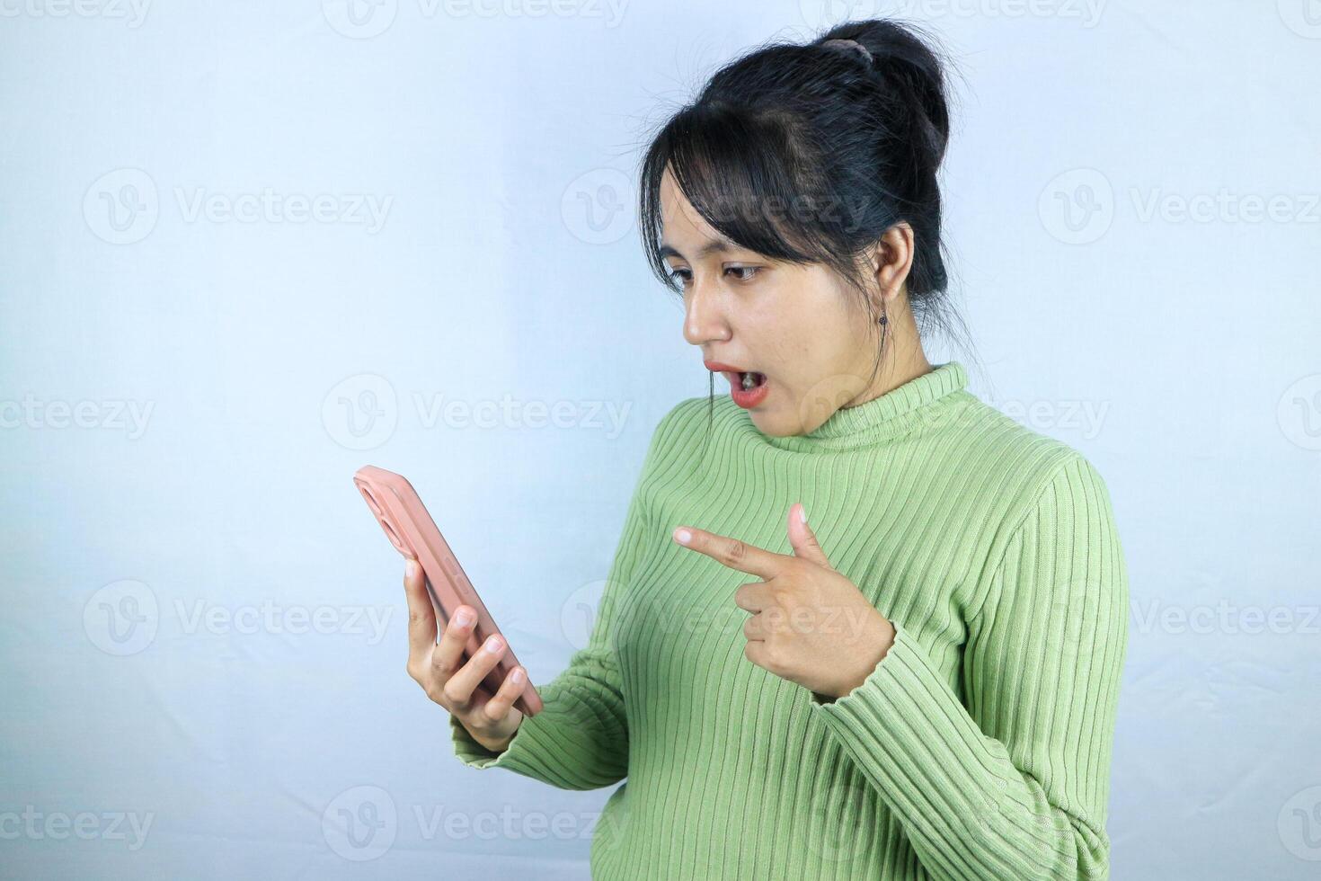 Shocked expression asian woman reading message on smart phone, on white background photo