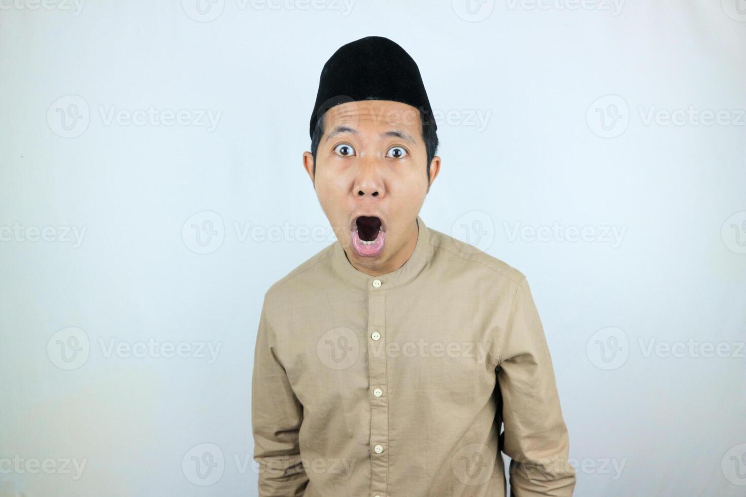 funny shocked and surprise expression asian muslim men wearing cap isolated on white background photo