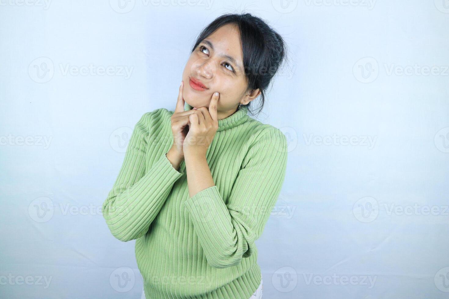 Young asian woman standing pose thinking on isolated white background. photo