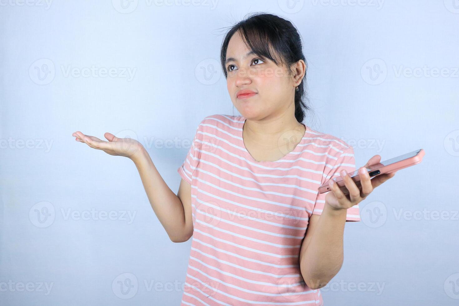 confuse expression of Asian woman holding smart phone on white background photo