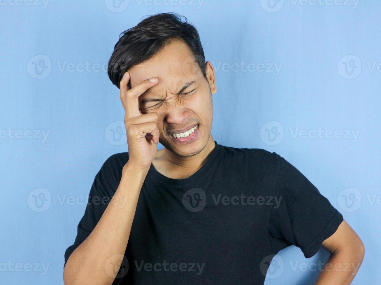 Handsome young man Hands holding head suffering from headache because pain and migraine. photo