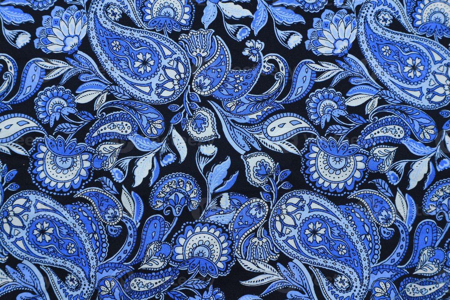 Blue paisley pattern fabric background photo
