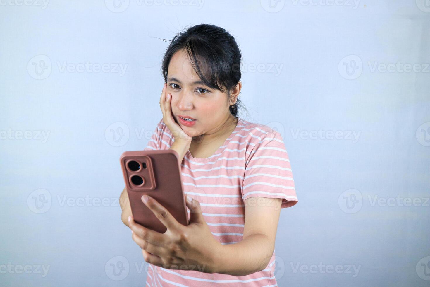 Shocked expression asian woman reading message on smart phone, on white background photo