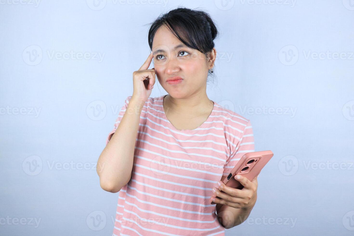 confuse expression of Asian woman holding smart phone on white background photo
