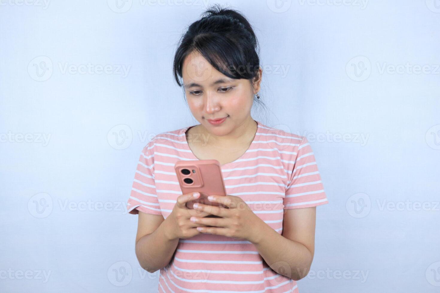 smiling expression asian woman reading good news on her smart phone on white background photo