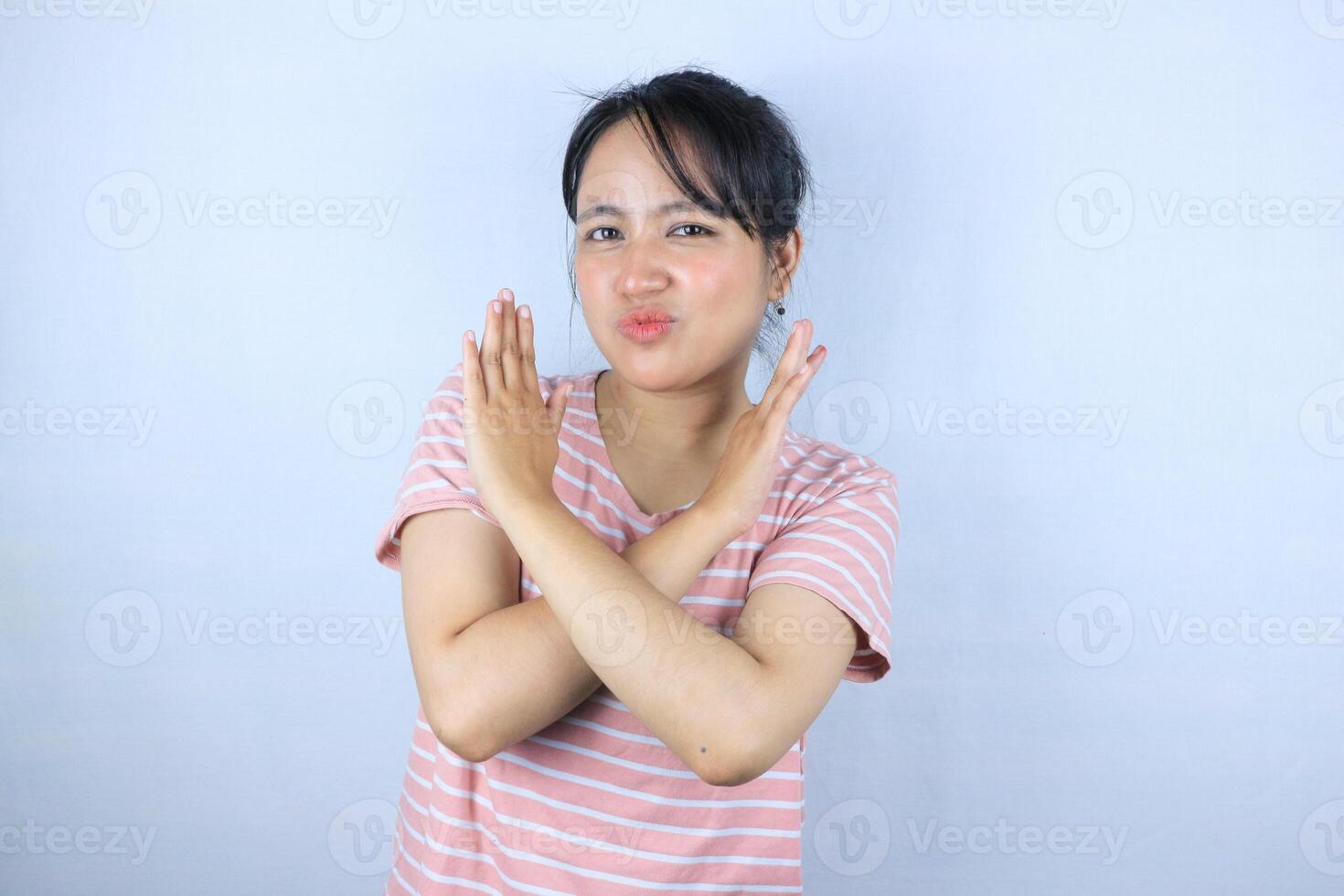 serious face expression asian woman showing crossed hands gesture and looking at camera photo