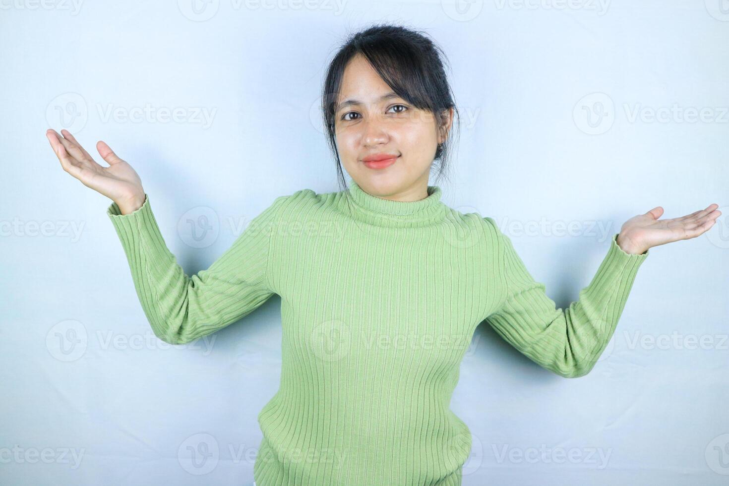 Portrait beautiful asian woman showing something with open hand palm smiling joyful and happy photo