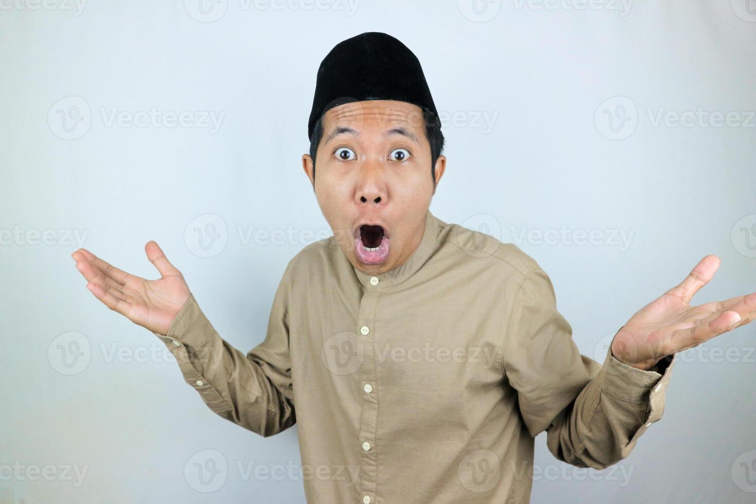 funny shocked and surprise expression asian muslim men wearing cap isolated on white background photo