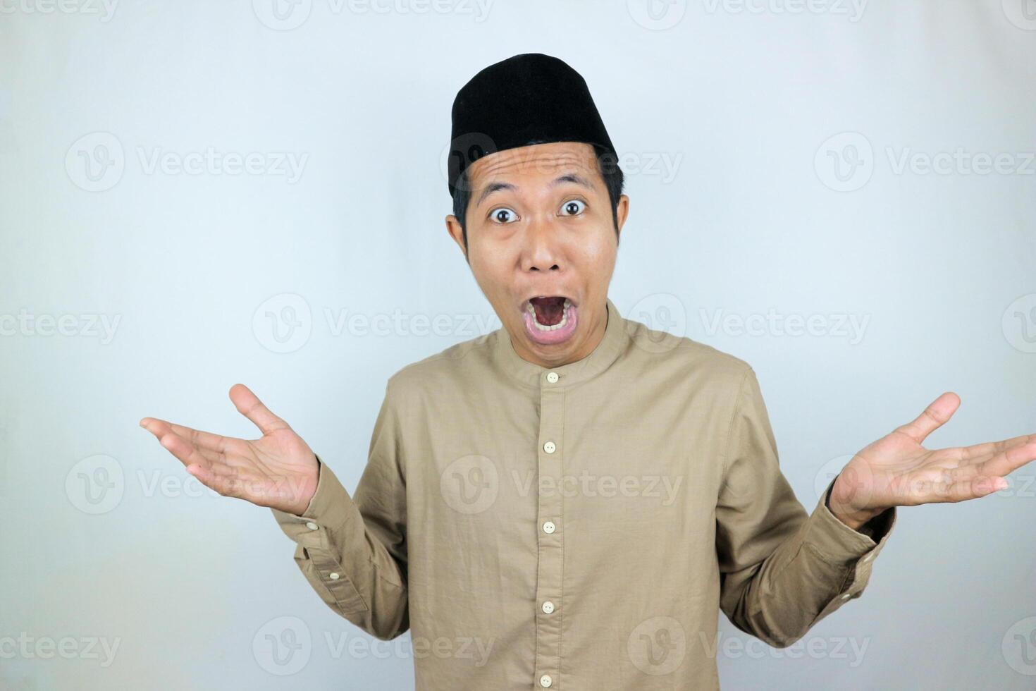 funny shocked and surprise expression asian muslim men wearing cap isolated on white background photo