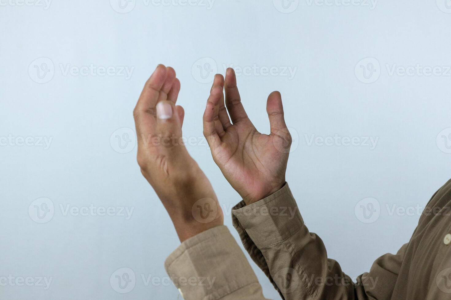 Male hand holding prayer beads rosary on white background. Ramadan kareem and ied mubarak concept. photo
