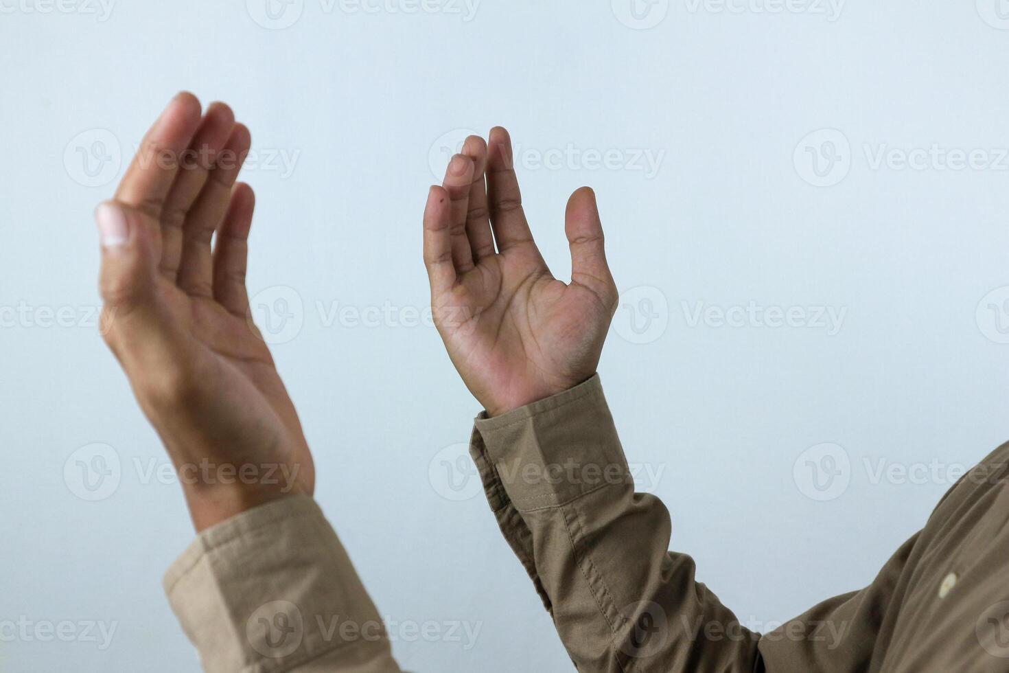 Male hand holding prayer beads rosary on white background. Ramadan kareem and ied mubarak concept. photo